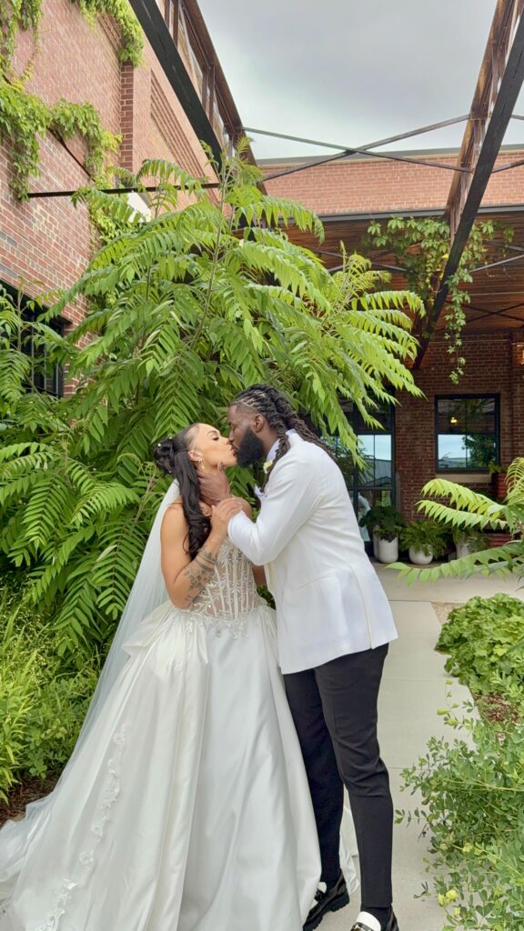 Bride and groom sharing a sweet kiss during their private first look before their wedding ceremony.